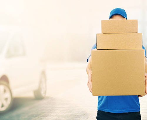 delivery man holding pile of cardboard boxes in front. copy space delivery man holding pile of cardboard boxes in front. copy space